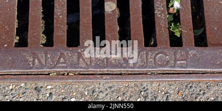 Iron street drainage grid, Nantwich, Cheshire, England, UK - embossed with the word Nantwich Stock Photo