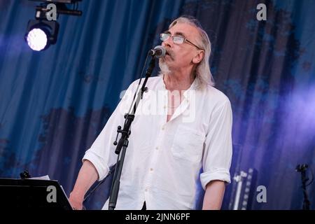 Cropredy, UK. 12th Aug, 2022. John Tams, English actor, singer, songwriter, composer and musician and son of a publican, former member of Derbyshire folk group Muckram Wakes, with British folk rock group Home Service performing live on stage at Fairport Convention's Cropredy Festival. Home Service is a British folk rock group, formed in late 1980 from a nucleus of musicians who had been playing in Ashley Hutchings' Albion Band. Their career is generally agreed to have peaked with the album Alright Jack and has had an influence on later work John Tams and several other members of the band, have Stock Photo
