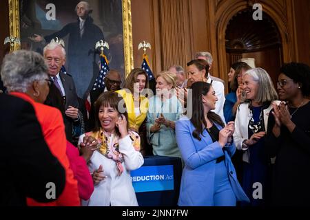 House Speaker Nancy Pelosi (D-CA) talks with Representative Carolyn Maloney (D-N.Y.) as members of the Democratic caucus celebrate during an enrollment ceremony after the House voted to pass the Inflation Reduction Act, at the U.S. Capitol, in Washington, DC, on Friday, August 12, 2022. Today the House of Representatives returned from August recess to vote on the Inflation Reduction Act, a $739 billion tax-and-energy bill filled with Democrat priorities that the Senate passed last week with no Republican support. (Graeme Sloan/Sipa USA) Stock Photo