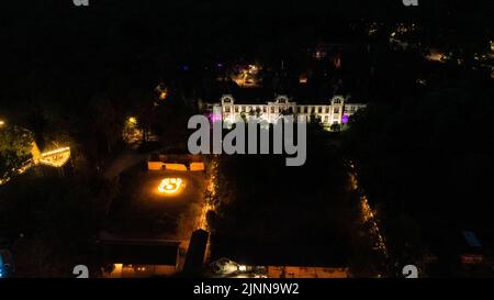 Germany. 12th Aug, 2022. 12 August 2022, Brandenburg, Beelitz-Heilstätten: The drone shot shows the light installations for the 'Long Nights at the Treetop Trail' campaign in Beelitz-Heilstätten. Various artists and musicians play for the visitors in the fabulously illuminated park. Photo: Gerald Matzka/dpa/ZB Credit: dpa picture alliance/Alamy Live News Stock Photo