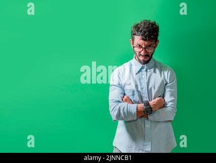 Angry and annoyed man with crossed arms isolated, Unhappy and angry person with crossed arms, Serious and angry man with crossed arms looking at Stock Photo