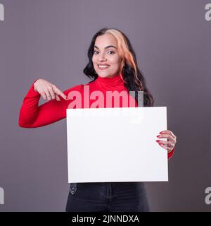 Beautiful woman pointing at a blank whiteboard Stock Photo
