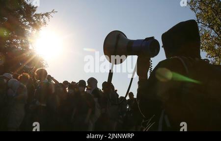 Hamburg, Germany. 13th Aug, 2022. Climate activists and participants of the climate camp start at a demonstration with flags and banners from the Volkspark to the port of Hamburg. Credit: Bodo Marks/dpa/Alamy Live News Stock Photo