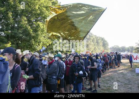 Hamburg, Germany. 13th Aug, 2022. Climate activists and participants of the climate camp start at a demonstration with flags and banners from the Volkspark to the port of Hamburg. Credit: Bodo Marks/dpa/Alamy Live News Stock Photo