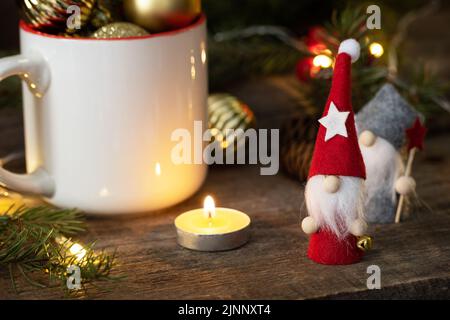 Vintage Christmas postcard design. Christmas gnomes with fir tree and gold christmas baubles decorations. Stock Photo