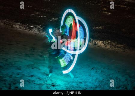 London, UK. 12th August, 2022. London Fire Spinners perform dramatic acts on the Thames shore at Gabriel's Wharf during a warm Friday evening. Credit: Guy Corbishley/Alamy Live News Stock Photo