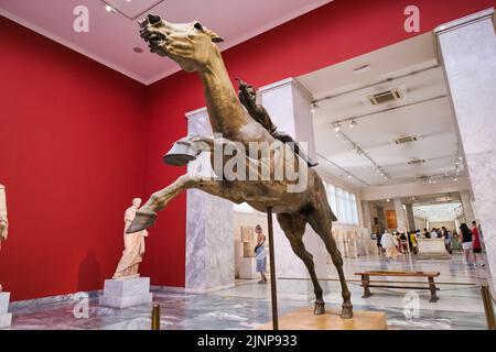 View of the horse bronze statue and the Jockey of Artemision inside the archeological museum in Athens