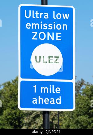 Close up of ULTRA LOW EMISSION ZONE sign against a clear blue sky. Stock Photo