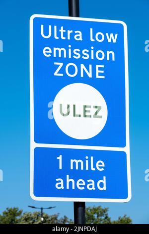 Close up of ULTRA LOW EMISSION ZONE sign against a clear blue sky. Stock Photo