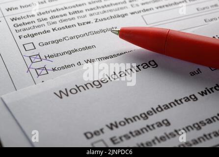 Dresden, Germany. 11th Aug, 2022. ILLUSTRATION - A pencil lies on a housing subsidy application on a table. (posed scene) Credit: Robert Michael/dpa/Alamy Live News Stock Photo