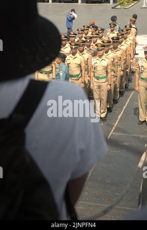 Indonesian navy cadets and officers lining up for a briefing, photographed from behind a visitor who standing on KRI Dewaruci (Dewa Ruci), an Indonesian tall ship, as the barquentine type schooner is opened for public visitors at Kolinlamil harbour (Navy harbour) in Tanjung Priok, North Jakarta, Jakarta, Indonesia. Stock Photo