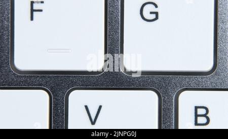 Close-up of a computer keyboard, with white keys. Stock Photo