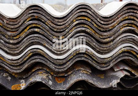A stack of wave slate. Gray wavy slate. Slate Roofing. Home construction, corrugated roof, profiled sheeting Stock Photo