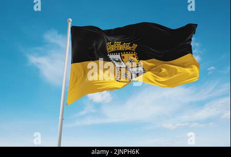 official flag of Yauco, Puerto Rico untied states of America at cloudy sky background on sunset, panoramic view. USA travel and patriot concept. copy Stock Photo