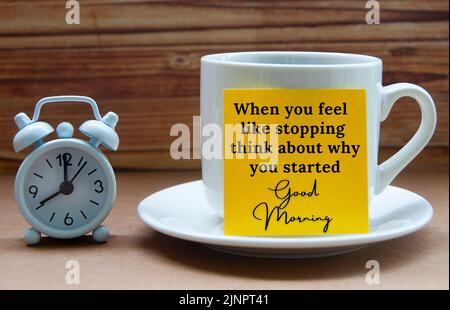 Motivational quote text on yellow notepad on coffee cup - When you feel like stopping think about why you started. Motivational and inspirational conc Stock Photo