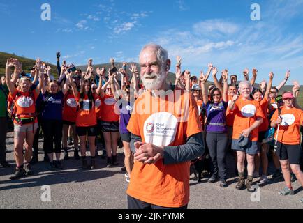 Nick Gardner, aged 82, with family, supporters and fellow walkers before setting off to the summit of his final mountain the Cairn Gorm after setting the goal of climbing all 282 Munros in 1200 days following his wife Janet being taken into care with Alzheimer's and osteoporosis. Picture date: Saturday August 13, 2022. Stock Photo