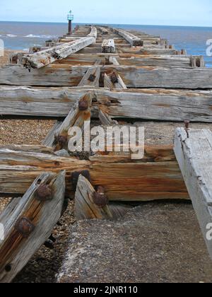 Used to transport sea mines to defend Harwich Harbour, the old wooden planks are all that's left of the railway jetty at Landguard Point, Felixstowe. Stock Photo