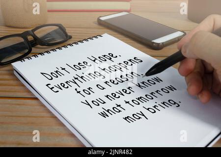 Motivational and inspirational quote written on notepad . Stock Photo