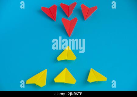 Red and yellow planes origami ready for battle. Battle concept. Stock Photo