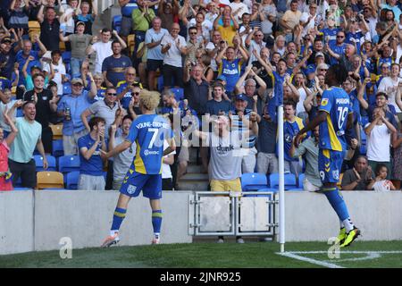 Wimbledon players celebrate after Nathan Young-Coombes scores during the Sky Bet League Two match at Cherry Red Records Stadium, London. Picture date: Saturday August 13, 2022. Stock Photo