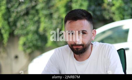 Bored and seedy thoughtful bearded young man. Man thinking about a problem Stock Photo