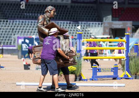 Herning, Denmark. 13th Aug, 2022. Equestrian sport, world championship, jumping. A figure from the writer Hans Christian Andersen is carried over the course. Credit: Friso Gentsch/dpa/Alamy Live News Stock Photo