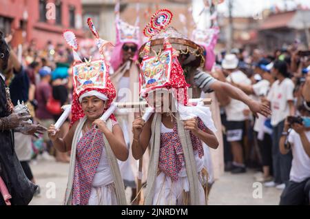 Kathmandu, Nepal. 13th Aug, 2022. Children dressed in traditional costumes take part in the festival. People celebrate Gai Jatra or cow festival in memory of the departed souls in the past year for salvation and peace. It is believed that cows guide the departed souls to cross the river to get to heaven. (Photo by Bivas Shrestha/SOPA Images/Sipa USA) Credit: Sipa USA/Alamy Live News Stock Photo