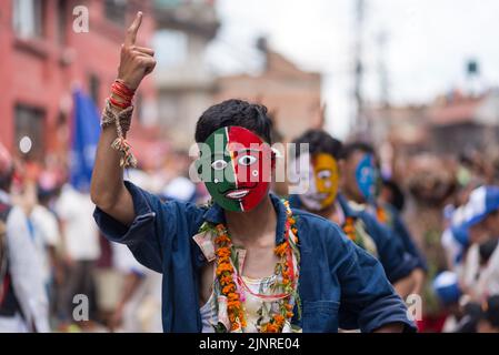 Kathmandu, Nepal. 13th Aug, 2022. Participants dressed in traditional costumes seen dancing during the festival. People celebrate Gai Jatra or cow festival in memory of the departed souls in the past year for salvation and peace. It is believed that cows guide the departed souls to cross the river to get to heaven. (Photo by Bivas Shrestha/SOPA Images/Sipa USA) Credit: Sipa USA/Alamy Live News Stock Photo