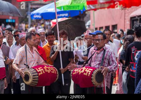 Kathmandu, Nepal. 13th Aug, 2022. A participants seen playing a musical instrument during the festival. People celebrate Gai Jatra or cow festival in memory of the departed souls in the past year for salvation and peace. It is believed that cows guide the departed souls to cross the river to get to heaven. (Photo by Bivas Shrestha/SOPA Images/Sipa USA) Credit: Sipa USA/Alamy Live News Stock Photo