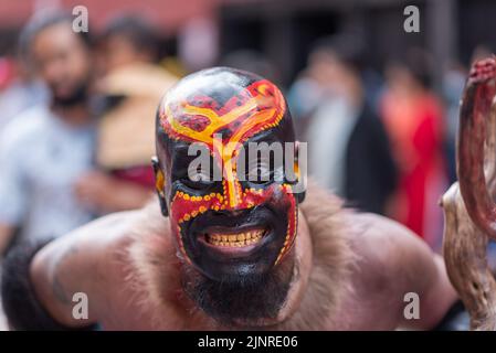 Kathmandu, Nepal. 13th Aug, 2022. A man with painted face seen during the Gai Jatra or cow festival procession. People celebrate Gai Jatra or cow festival in memory of the departed souls in the past year for salvation and peace. It is believed that cows guide the departed souls to cross the river to get to heaven. (Photo by Bivas Shrestha/SOPA Images/Sipa USA) Credit: Sipa USA/Alamy Live News Stock Photo