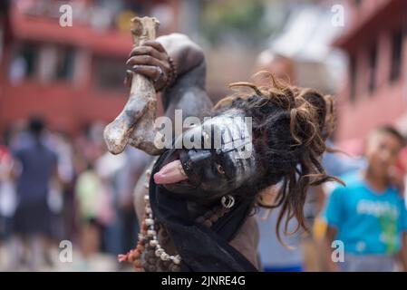 Kathmandu, Nepal. 13th Aug, 2022. A man with painted face seen during the Gai Jatra or cow festival procession. People celebrate Gai Jatra or cow festival in memory of the departed souls in the past year for salvation and peace. It is believed that cows guide the departed souls to cross the river to get to heaven. (Photo by Bivas Shrestha/SOPA Images/Sipa USA) Credit: Sipa USA/Alamy Live News Stock Photo