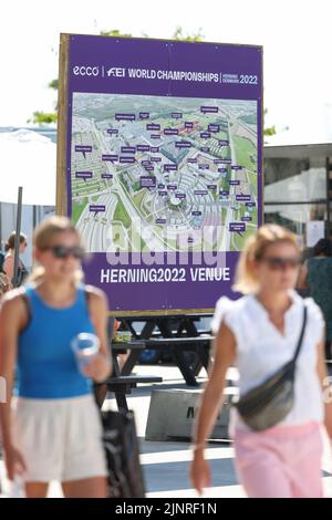 Herning, Denmark. 13th Aug, 2022. Equestrian sport, world championship, show jumping. Visitors walk along an overview map of the event site. Credit: Friso Gentsch/dpa/Alamy Live News Stock Photo
