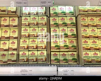 13.08.2022, Ukraine, Kharkiv, a shelf in a supermarket with processed cheese. Delicious processed soft cheese in a package. High quality photo Stock Photo