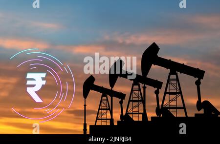 oil pump jack machine on blur red sky background with rupee symbol. concept for daily increasing, petrol, gasoline, and oil prices in india. Stock Photo