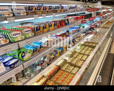 13.08.2022, Ukraine, Kharkiv, a shelf in a supermarket with processed cheese. Delicious processed soft cheese in a package. High quality photo Stock Photo