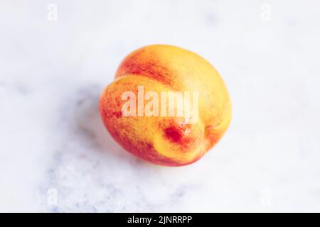 Apricot on White Marble Background Stock Photo