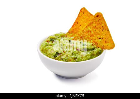 Bowl of fresh guacamole and nachos on white background Stock Photo