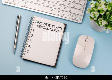 2023 New Year Resolutions Text On Note Pad Stock Photo
