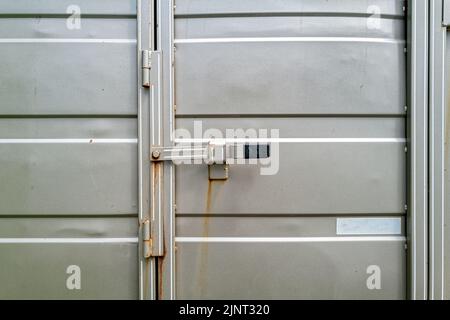 Latch on the rear door of a silver metallic horse trailer Stock Photo