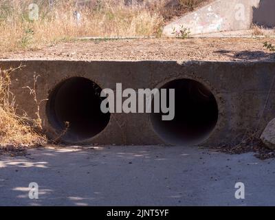 drainage pipe in the middle of a forest. Pollution concept. Stock Photo