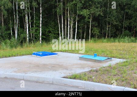 Two underground fuel storage tanks on the territory of a gas station, equipped platform. Stock Photo
