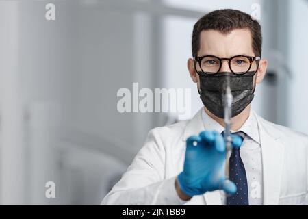 Closeup portrait of male doctor holding cartridge syringe Stock Photo