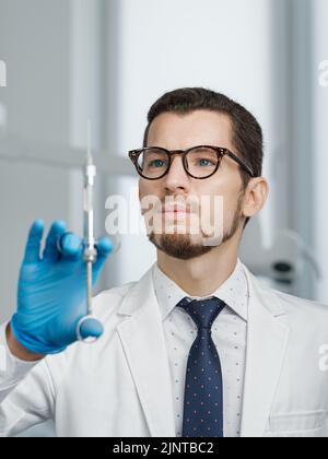 Closeup portrait of male doctor holding cartridge syringe Stock Photo