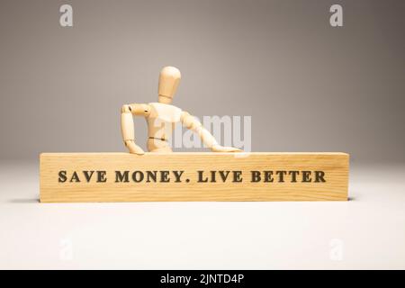 Save money, life better written on wooden surface. Motivation and personal development Stock Photo