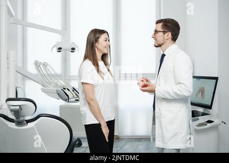 Female patient have a conversation with dentist in dental office Stock Photo
