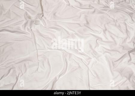 Crumpled white sheet texture with messy abstract pattern Stock Photo