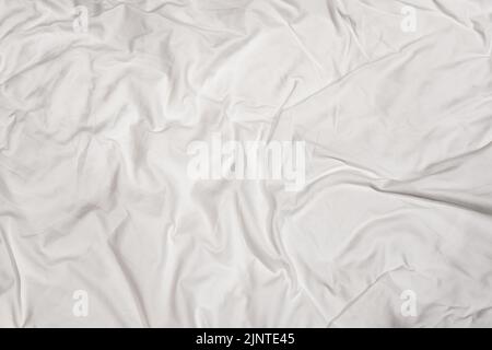 Closeup texture of crumpled white bed sheet with messy abstract pattern Stock Photo