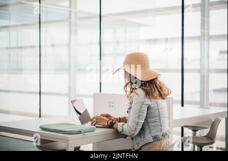 Anonymous woman working on remote project in airport Stock Photo