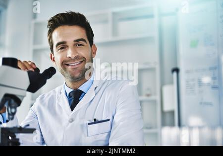 Guess who made a new breakthrough discovery. Portrait of a scientist using a microscope in a lab. Stock Photo