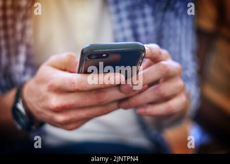 Every student cant go without their connections. Closeup shot of an unrecognizable university student using a cellphone at campus. Stock Photo